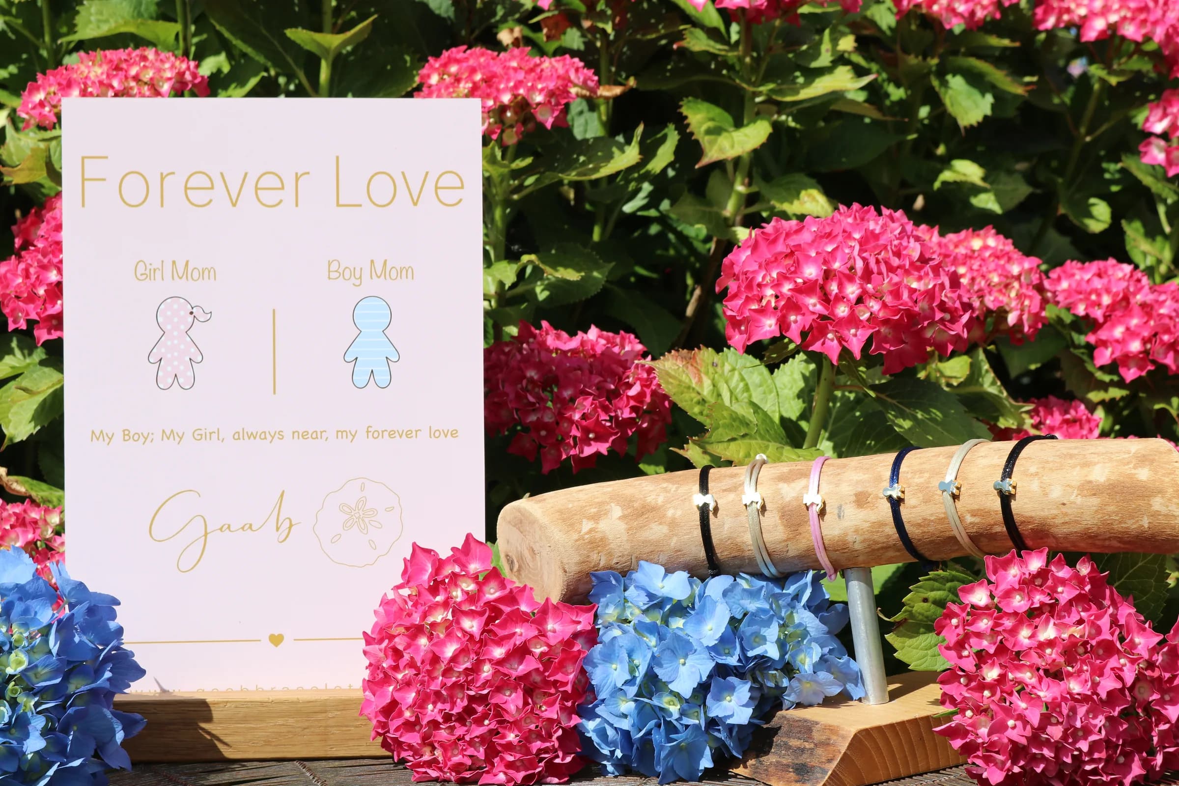 Forever Love bracelet wholesale display among pink and blue hydrangeas